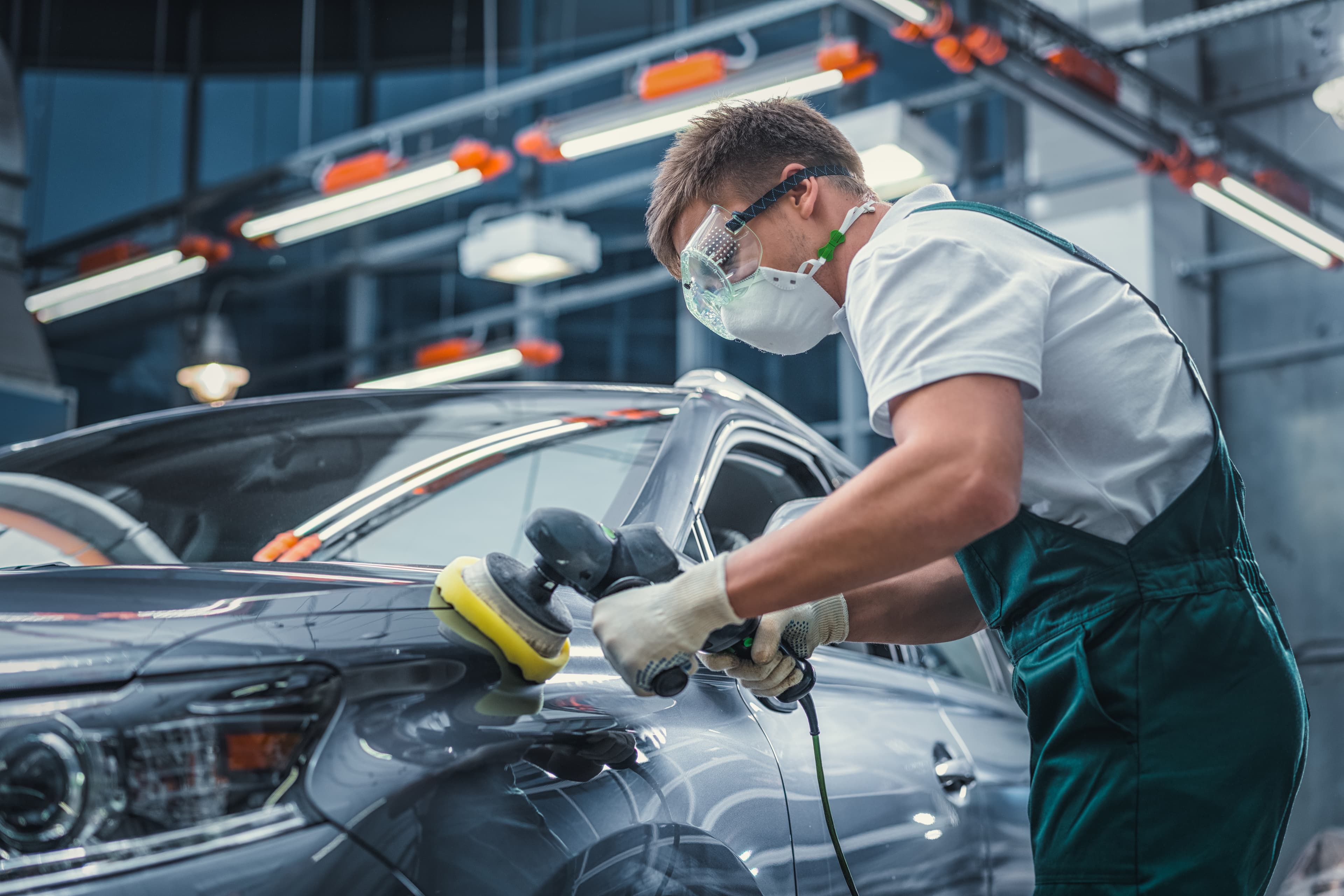 Technician polishing a vehicle at Interstate Auto Body